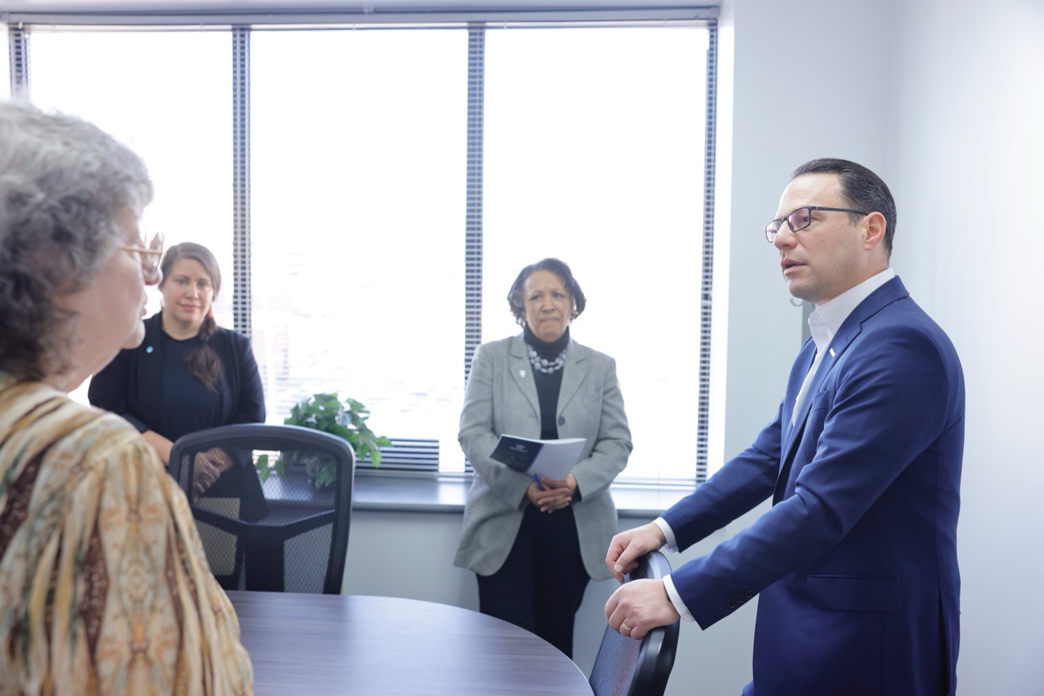 Governor Shapiro with legal aid staff looking on